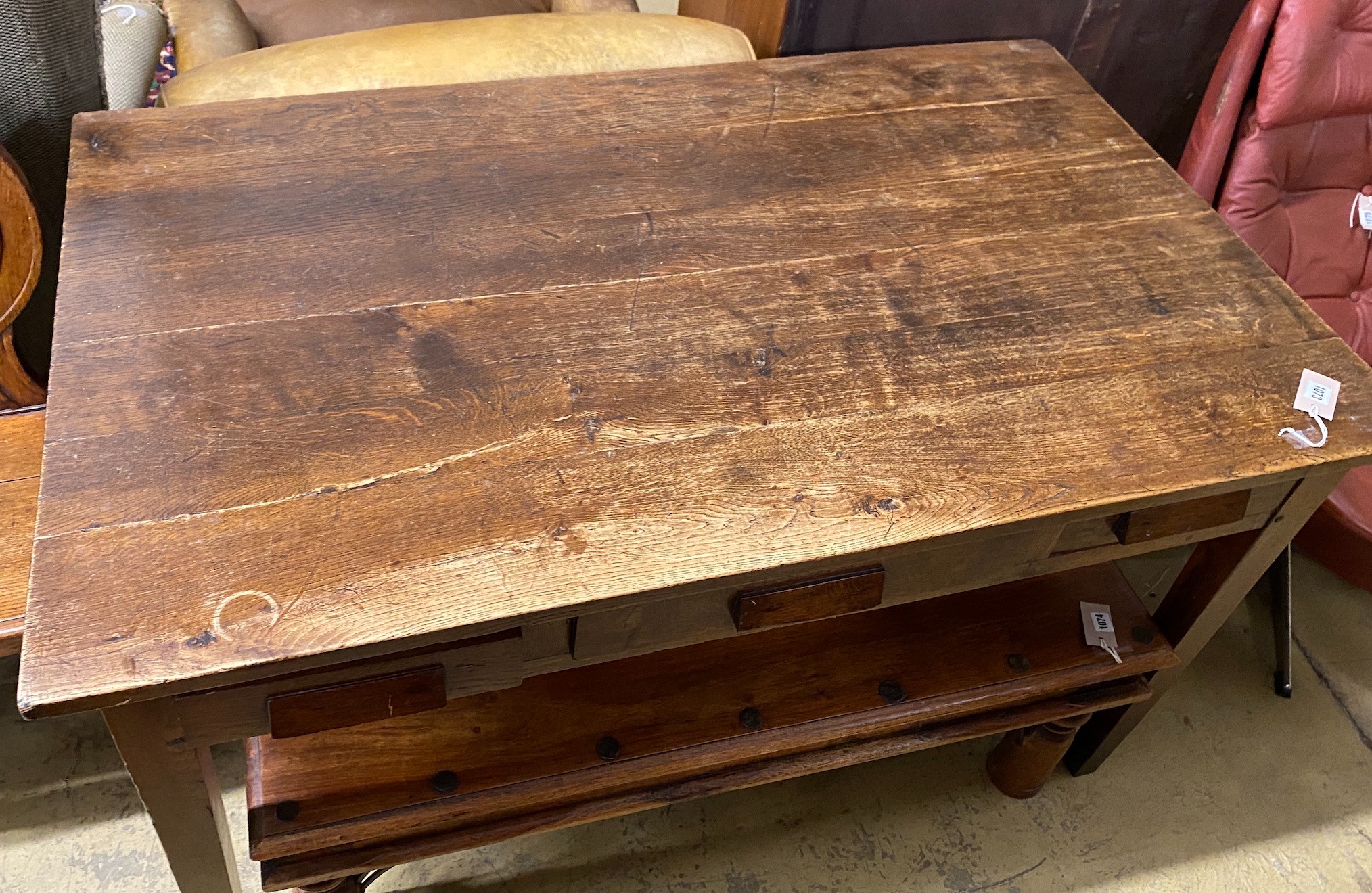 A mid century oak writing table with planked top and three drawers, length 130cm, depth 78cm, height 78cm